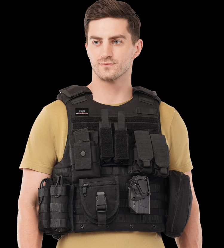 Man wearing a black Tactical Carrier - MRAP vest by Hard Shell with multiple pouches and attachments over a tan t-shirt.