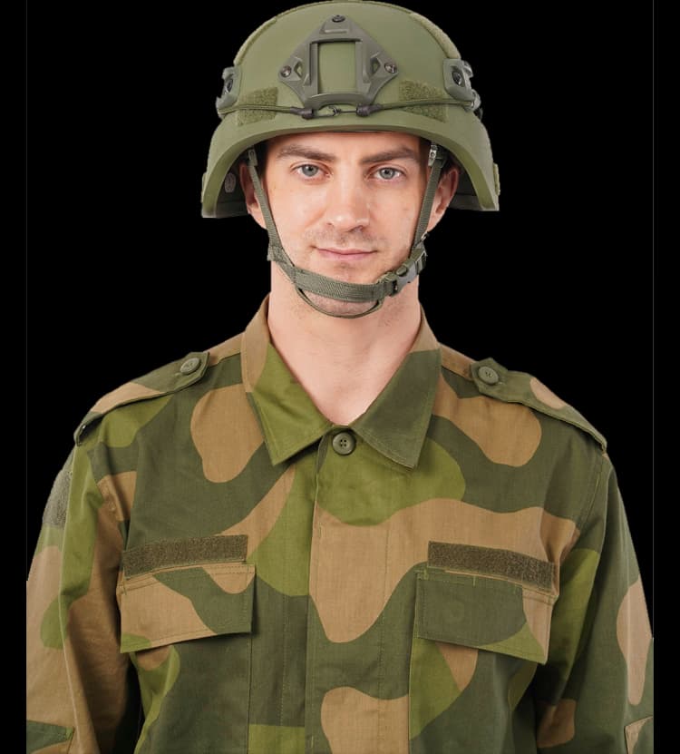 Front portrait of person wearing a green MICH helmet and camouflage uniform with chin strap secured.
