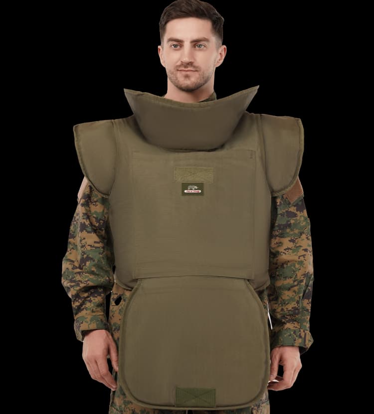 A person in camouflage uniform wearing an olive-green demining vest with full neck, shoulder, and groin protection.
